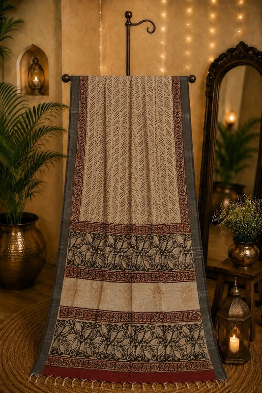 Beige Linen Kalamkari Saree with Tribal Print Body & Artistic Floral Border