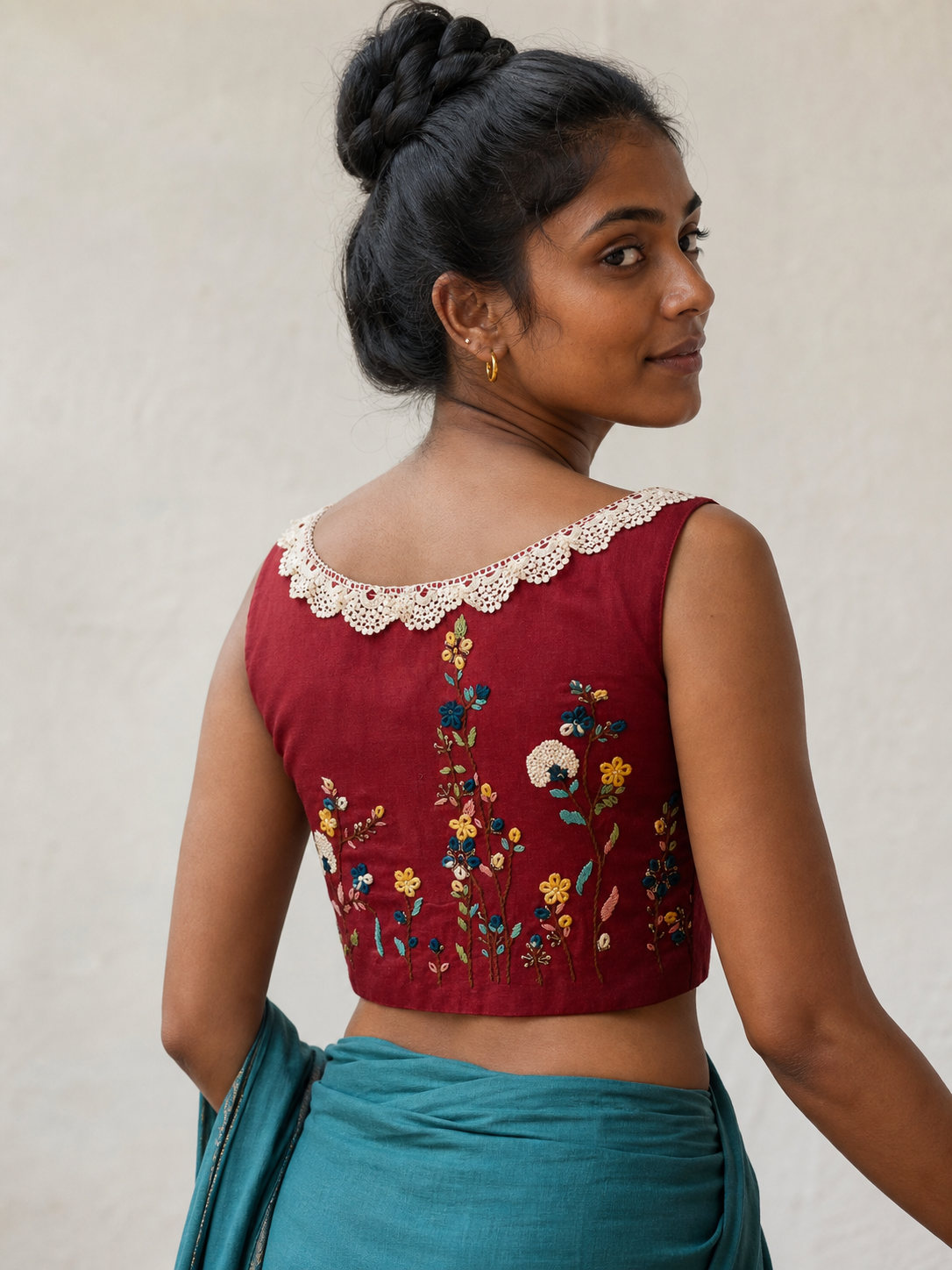 Maroon sleeveless cotton blouse with floral back embroidery worn by model