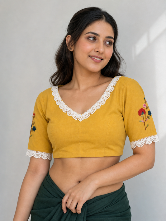 Mustard cotton V-neck blouse with embroidered sleeves worn by model