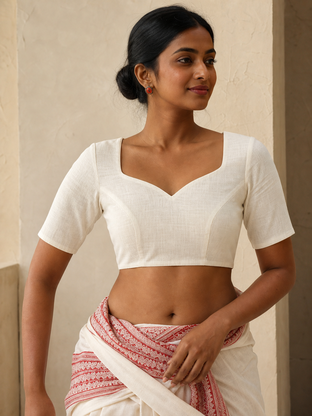 Off-white cotton blend sweetheart-neck blouse worn by model